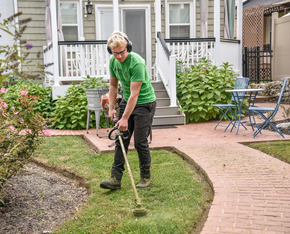 Landscaper trimming a hedge