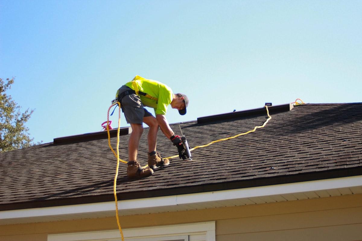 Roofer installing shingles